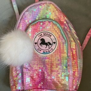 Justice mini backpack/purse w/Pom Pom. Clear sequins over ombré rainbow colors.